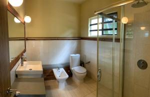 a bathroom with a toilet and a sink and a shower at Beautique Studios Lot 78 in La Gaulette