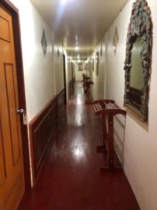 an empty hallway with a mirror and a table at Phi Phi Dream Guest House in Phi Phi Islands