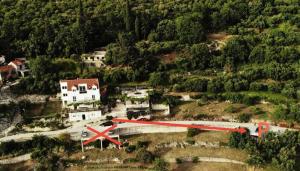 a small plane on a road in front of a house at Apartments Cypress Sea Cove in Slano