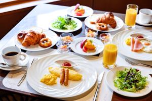 a table with plates of breakfast foods and drinks at Sheraton Miyako Hotel Osaka in Osaka +87 photos