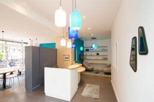 a kitchen and dining room with a table and chairs at La Regence in Courbevoie