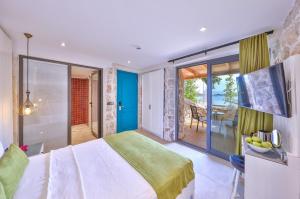 a bedroom with a large bed and a balcony at Jasmine Otel in Kaş