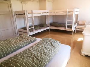 a room with three bunk beds and a bed at Frogner Hovedgård in Skien
