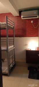 a room with bunk beds and a desk and a sink at The Cultural Crashpad - 康乃馨旅館 in Hong Kong