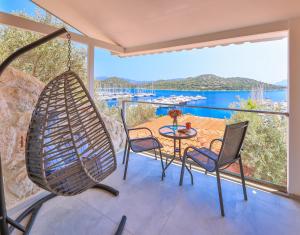 a room with a table and chairs and a large window at Jasmine Otel in Kaş