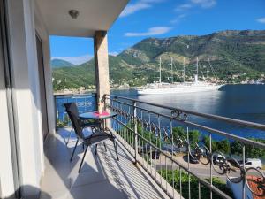a balcony with a view of the water and a cruise ship at Apartment Galina in Tivat