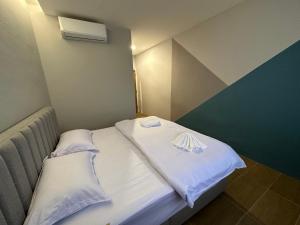 a small room with a bed with white sheets at A1 Hotel Sungai Petani in Sungai Petani