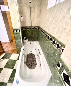 La salle de bains est pourvue d'une baignoire et de carrelage. dans l'établissement Amplio ático junto a la catedral, à León