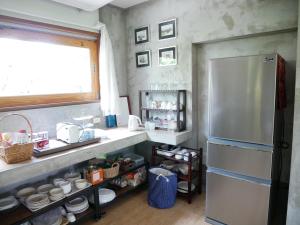 a kitchen with a stainless steel refrigerator and a window at Time Pala-U Garden Villa (Noncee House) in Ban Pa Lau