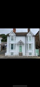 a large white house with a green door at Vine Cottage - Sandgate in Sandgate