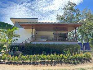 a house with a porch on the side of it at The Little Waterfall Phangan in Thong Nai Pan Noi