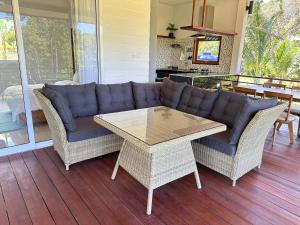a living room with a couch and a table at The Little Waterfall Phangan in Thong Nai Pan Noi