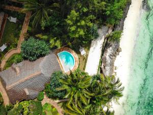 an aerial view of a resort with a pool and a beach at Tulia Zanzibar Unique Beach Resort in Pongwe