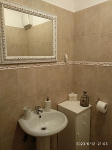 a bathroom with a sink and a mirror at Studio Apartman Marti in Kostrena