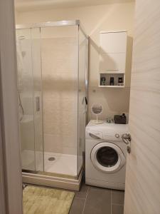 a bathroom with a shower and a washing machine at NEW - Frendly Luxury Apartment Franka Zagreb in Zagreb