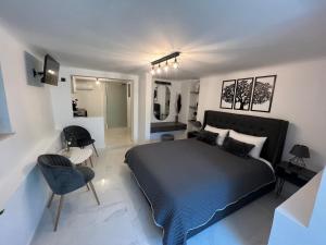 a bedroom with a large bed and a bathroom at Riviera-MelRod-Athens in Athens