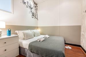 a bedroom with a bed with two stuffed animals on it at Sweet Inn - Ponthieu V in Paris