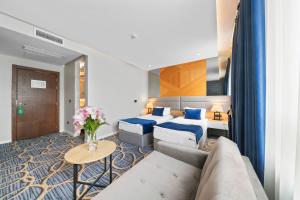 Postel nebo postele na pokoji v ubytování Sky Hotel