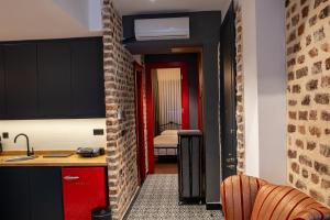 a kitchen with red cabinets and a room with a bedroom at Alness Residence in Istanbul