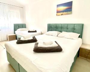 a bedroom with two beds with towels on them at Apartments Domane Nenad in Neum