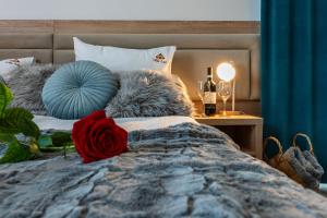 una camera da letto con un letto con una rosa rossa sopra di Villa Astra - Apartments & Restaurant a Oświęcim