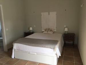 a bedroom with a white bed with two night stands at Monte Teu in São Luis