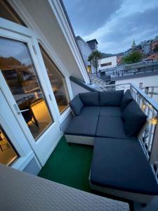 a balcony with a couch sitting on a balcony at Penthouse with private balcony in the city centre of Bergen in Bergen