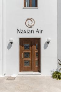 a door to a nashan air sign on a building at Naxian Air in Agios Georgios