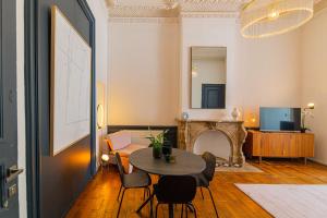 a living room with a table and a fireplace at Garden Guillemins Station in Liège