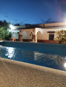 a house with a swimming pool at night at Casa Rural San Antonio in La Puebla de los Infantes