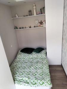 a small bed in a corner of a room at Apartament w sercu Malborka in Malbork