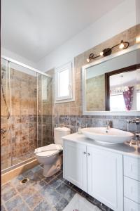 a bathroom with a toilet and a sink and a shower at Agios Nikitas Supreme Villa in Agios Nikitas +46 photos