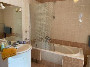 a bathroom with a tub and a sink at Terrace Apartment in Hvar +69 photos