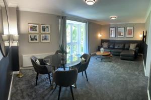 a living room with a couch and a table and chairs at The Tontine Hotel in Greenock