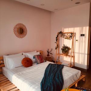 a bedroom with a large white bed with a mirror at Homestay xinh Ecopark in HÆ°ng YÃªn
