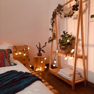 a bedroom with a bed with lights and a ladder at Homestay xinh Ecopark in HÆ°ng YÃªn