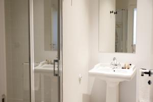 a white bathroom with a sink and a shower at Casa Alberola Apartments in Alicante +28 photos