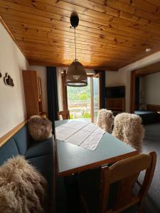 a dining room with a table and two stuffed animals at Panoramaalm - Ski in - Ski out in Bad Kleinkirchheim