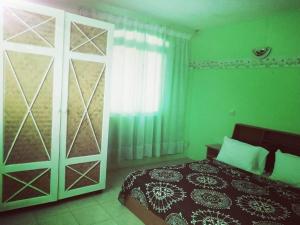 a bedroom with a bed and a sliding glass door at El Paraiso in La Gaulette