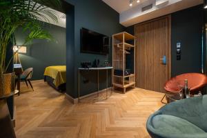 a room with a bedroom with a bed and a tv at Sava Boutique Hotel in Warsaw