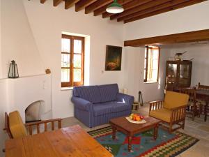 a living room with a blue couch and a table at Porfyrios Country House in Chirokitia