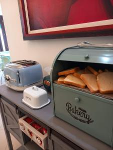 a toaster sitting on a counter with bread in it at Hotel Villa Ionia in Avola