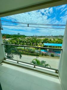 a window with a view of a beach and palm trees at Laguna beach 3 the Maldives in Jomtien Beach