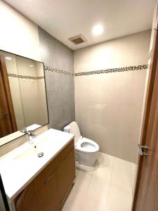 a bathroom with a toilet and a sink and a mirror at Laguna beach 3 the Maldives in Jomtien Beach