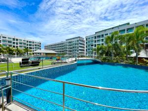 a large swimming pool in front of some buildings at Laguna beach 3 the Maldives in Jomtien Beach +4 photos