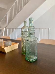 two glass bottles sitting on top of a table at Modern beachfront townhouse in El Perelló