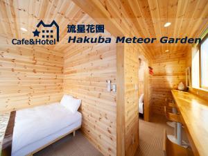 a sauna with a bed in a wooden room at Meteor Garden in Hakuba