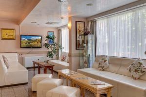 a living room with white furniture and a large window at Paraiso Theopolis - All Inclusive in Obzor