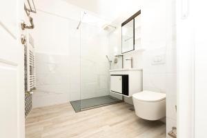 a white bathroom with a toilet and a shower at Apart HOTEL Fusion Tower in Iaşi