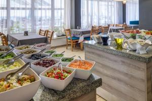 a buffet line with many dishes of food on tables at Paraiso Theopolis - All Inclusive in Obzor